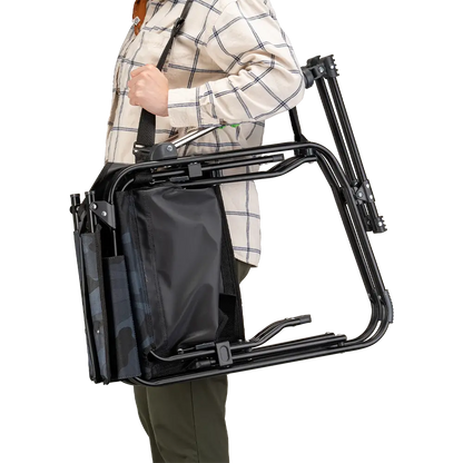 A person carrying the Stealth Camo Stowaway Rocker with a carry strap. 