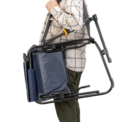 A person carrying the Navy Topo Stowaway Rocker with a carry strap. 