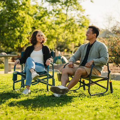 A couple sitting in two Grab and Go Rockers while enjoying the park. 