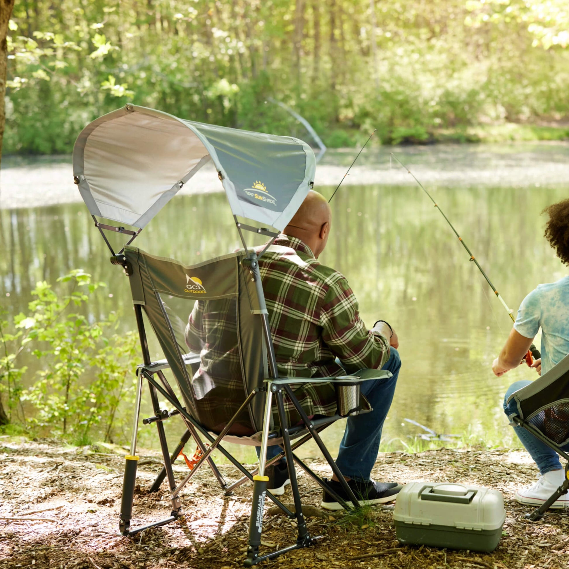 all-groups A man fishing with his daughter while sitting in a gray Sunshade Rocker. 